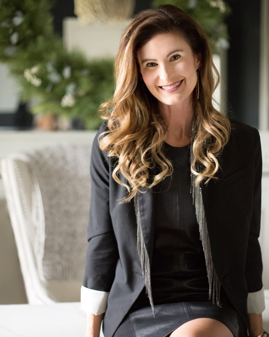 Melissa Asbury seated at a marble counter and smiling
